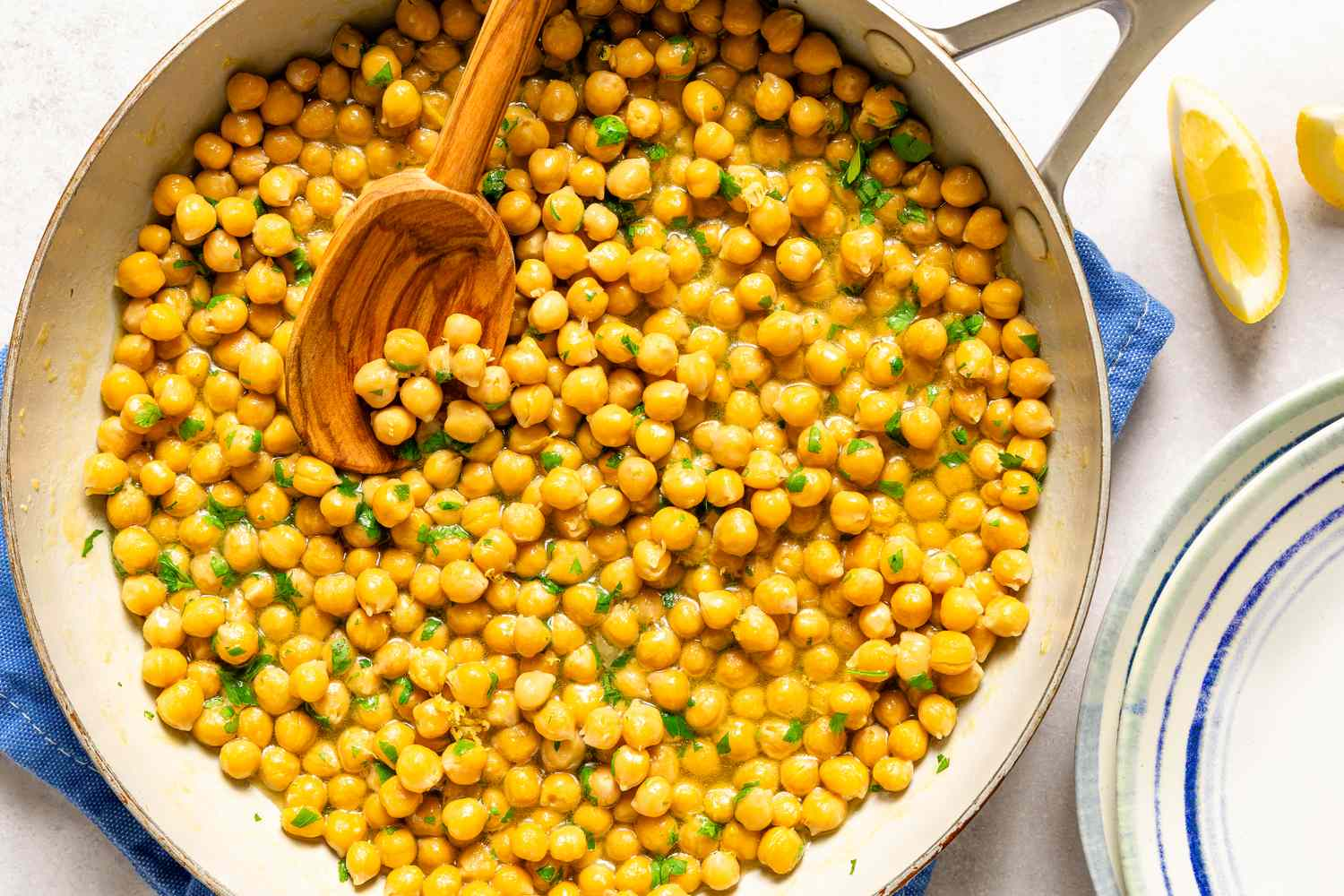 Bowl of cooked chickpeas on a wooden surface