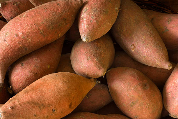 Sweet potatoes on a rustic wooden surface